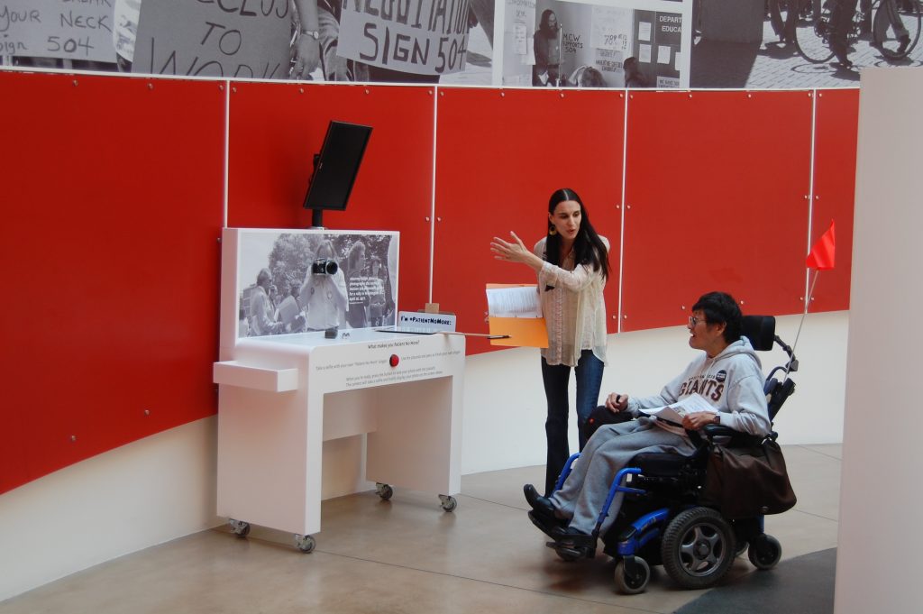 Detail of photo station where visitors pose with their own protest slogan sign