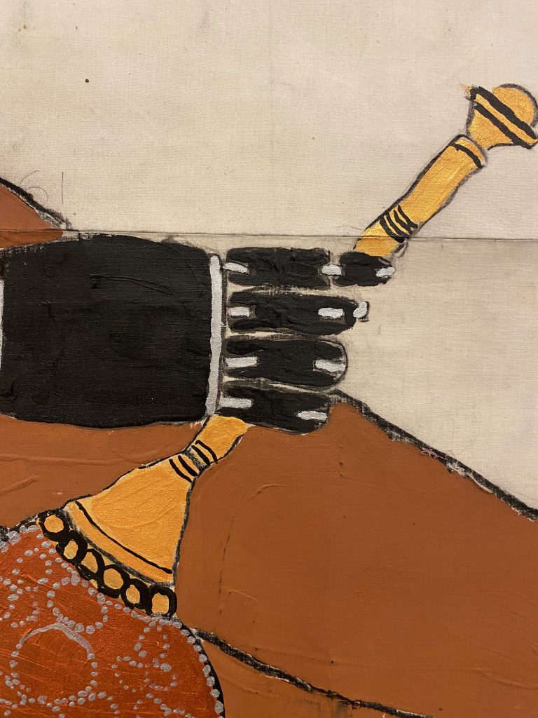 Detail of a painting of a right prosthetic hand carrying an orange handled decorated fan by a brown body.